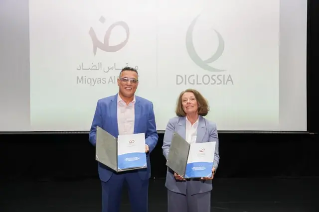 Eyad Darawsheh, General Manager of Arabic Scale Educational Consultancy LLC, and Mimi Jett, Founder and CEO of Diglossia, display the partnership agreement that will integrate the Miqyas Al Dhad reading scale into Diglossia's digital literacy and assessment platforms. Image Courtesy: Miqyas Al Dhad