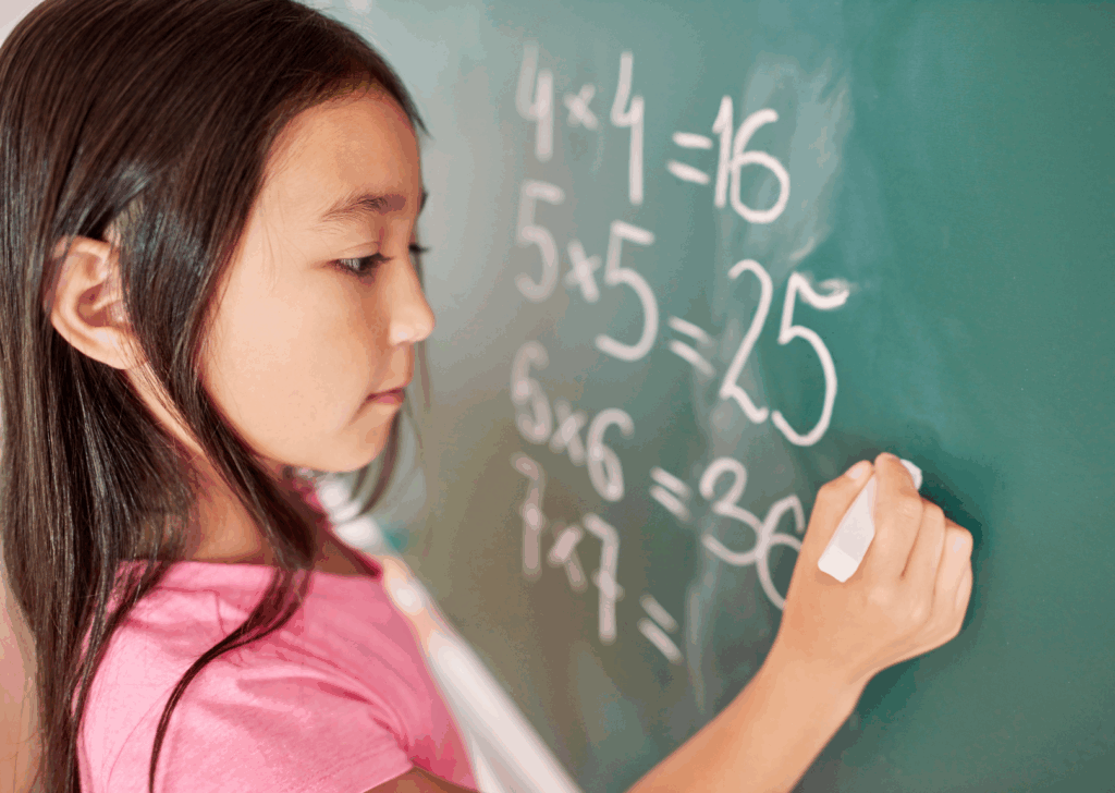 A student answers simple arithmetic problems on a chalkboard. How do we solve America's math problem?